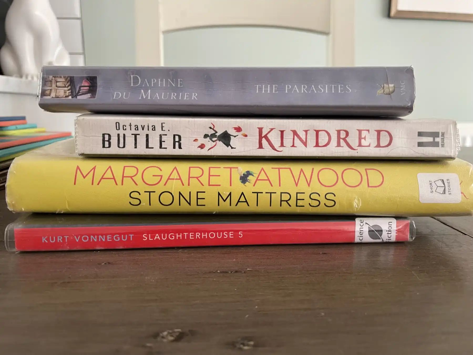 Stack of books, spines read: Daphne DuMaurier – The Parasites, Octavia E Butler – Kindred, Margaret Atwood – Strone Mattress, Kurt Vonnegut – Slaughterhouse 5